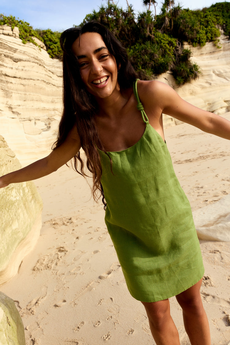 Tevi Linen Short Slip Dress in Lime Green - woman in outdoor setting, scoop neckline and braided straps - Lilly Pilly Collection