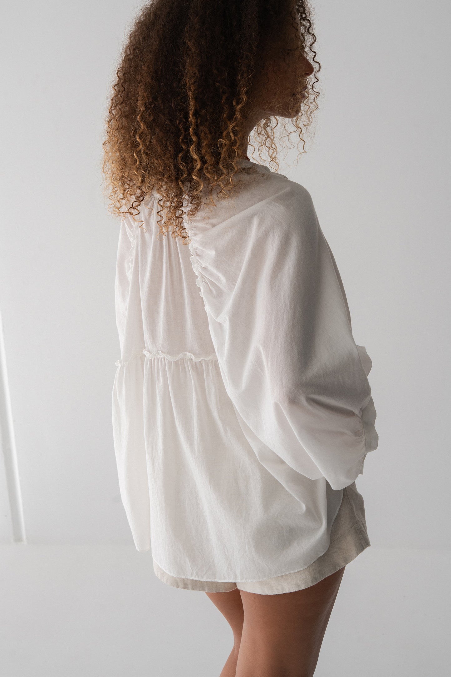 Thalia Cotton Voile Shirt in Ivory - back view, gathered back yoke and balloon sleeves, worn with ivory shorts - Lilly Pilly Collection