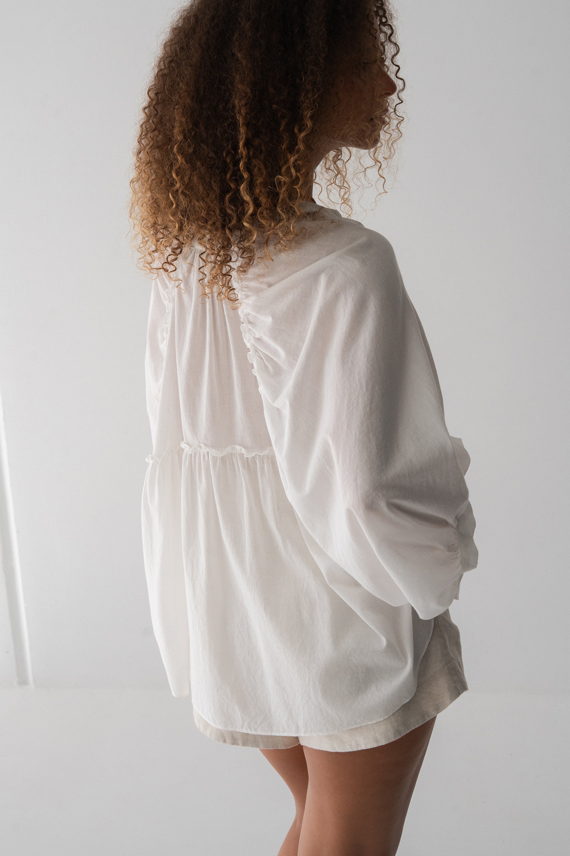 Thalia Cotton Voile Shirt in Ivory - back view, gathered back yoke and balloon sleeves, worn with ivory shorts - Lilly Pilly Collection