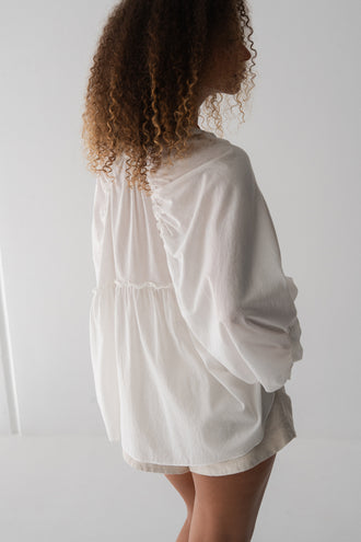 Thalia Cotton Voile Shirt in Ivory - back view, gathered back yoke and balloon sleeves, worn with Gaia Linen Shorts in Ivory - Lilly Pilly Collection