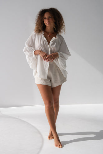Thalia Cotton Voile Shirt in Ivory - side view, balloon sleeves, worn with Gaia Linen Shorts in Ivory - Lilly Pilly Collection