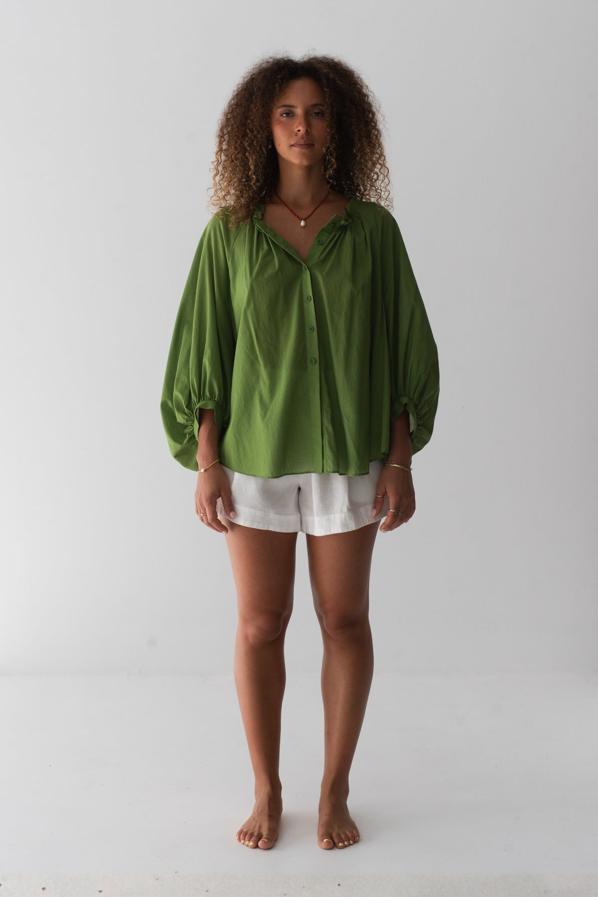 Thalia Cotton Voile Shirt in Lime Green - back view, gathered back yoke and balloon sleeves, worn open as beach cover-up - Lilly Pilly Collection