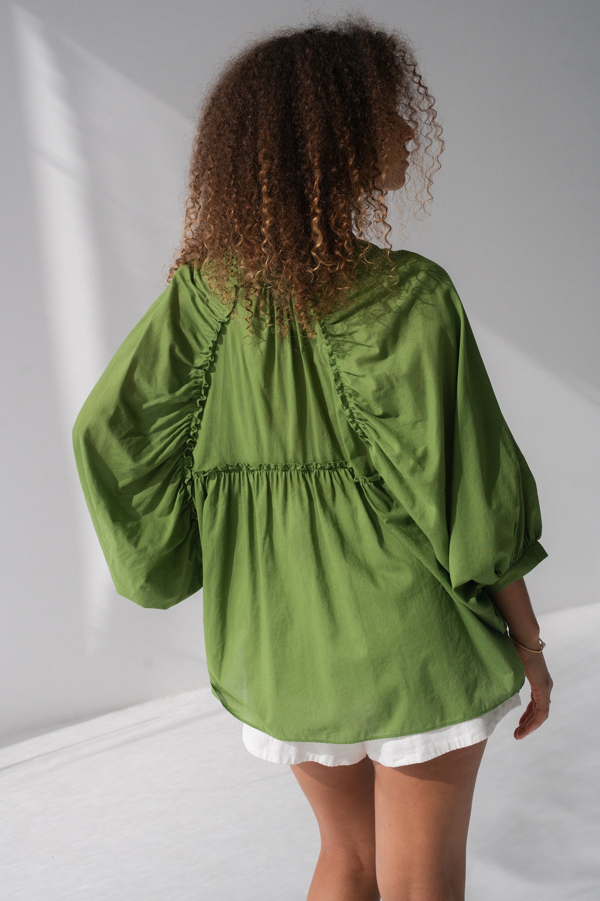 Thalia Cotton Voile Shirt in Lime Green - back view, gathered back yoke and balloon sleeves, worn open as beach cover-up - Lilly Pilly Collection