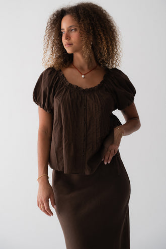 Tilly Cotton Voile Shirt in Chocolate - three-quarter view, gathered ruffle neckline and pintuck detail, puff sleeves, worn with matching Riley Bias Linen Midi Skirt in Chocolate - Lilly Pilly Collection