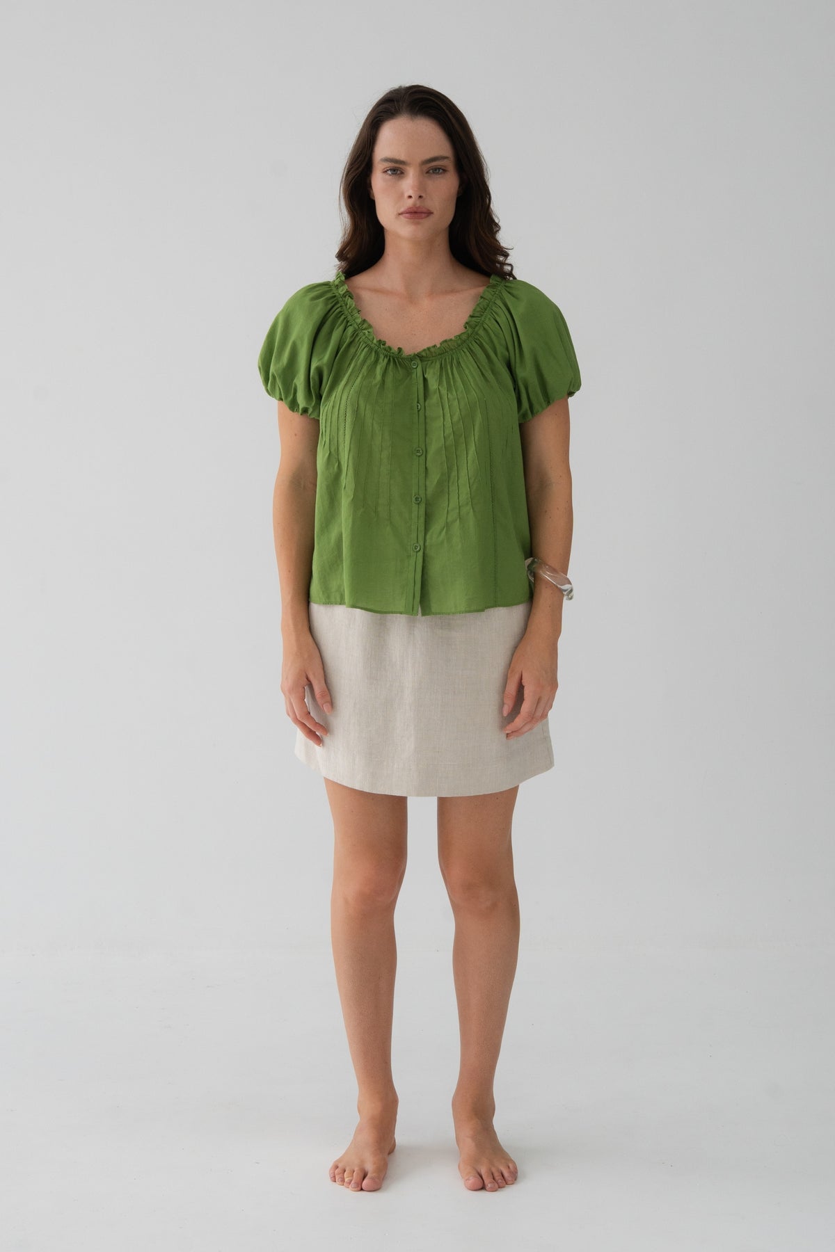 Tilly Cotton Voile Shirt in Lime Green - front view, gathered ruffle neckline and button-front, pintuck detail, puff sleeves, worn with Anelle Linen Mini Skirt in Oatmeal - Lilly Pilly Collection