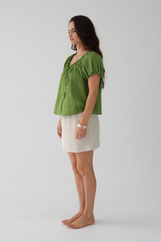Tilly Cotton Voile Shirt in Lime Green - side view, gathered ruffle neckline and puff sleeves, worn with Anelle Linen Mini Skirt in Oatmeal - Lilly Pilly Collection