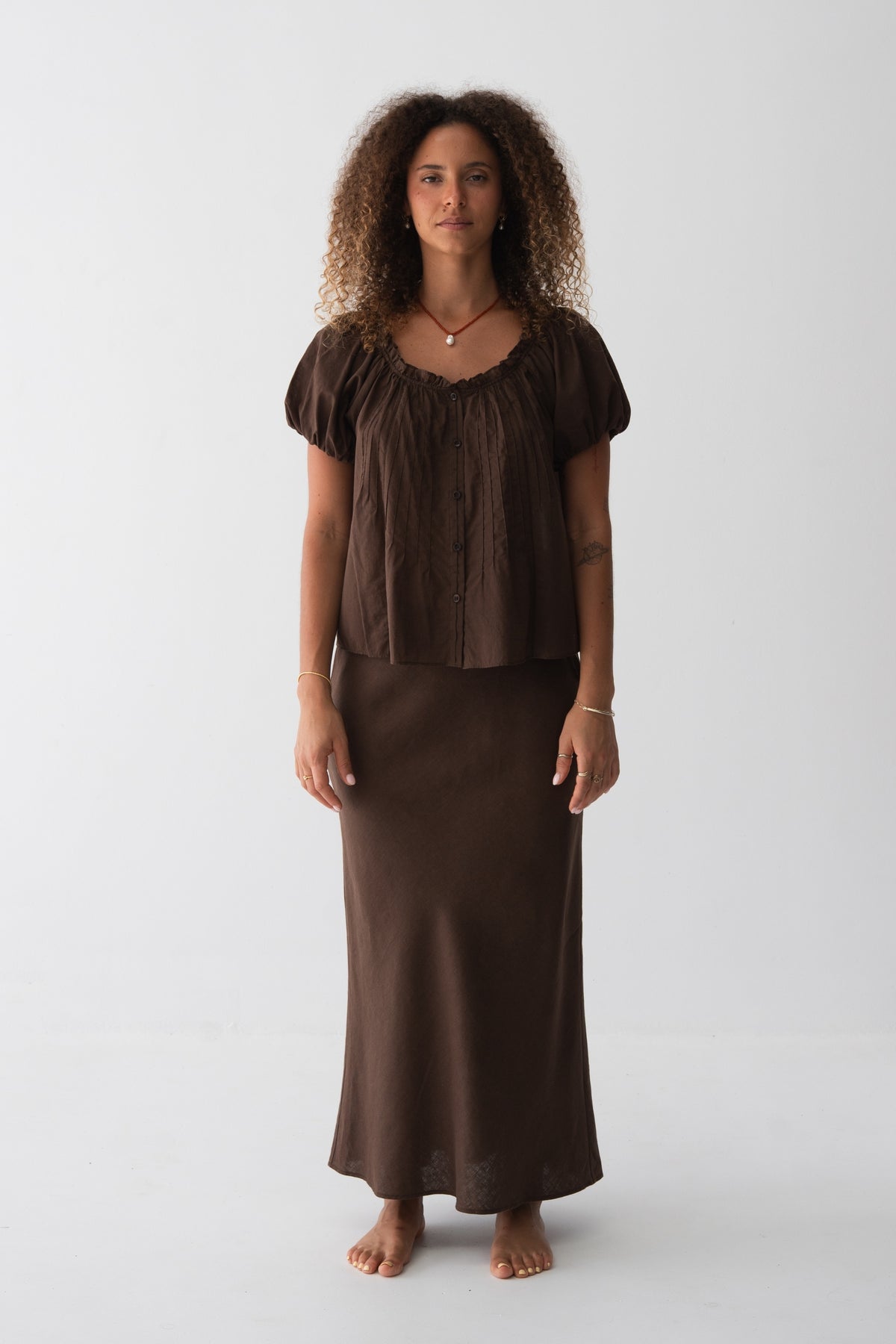 Tilly Cotton Voile Shirt in Chocolate - full length front view, gathered ruffle neckline and pintuck detail, puff sleeves, worn with matching Riley Bias Linen Midi Skirt in Chocolate - Lilly Pilly Collection