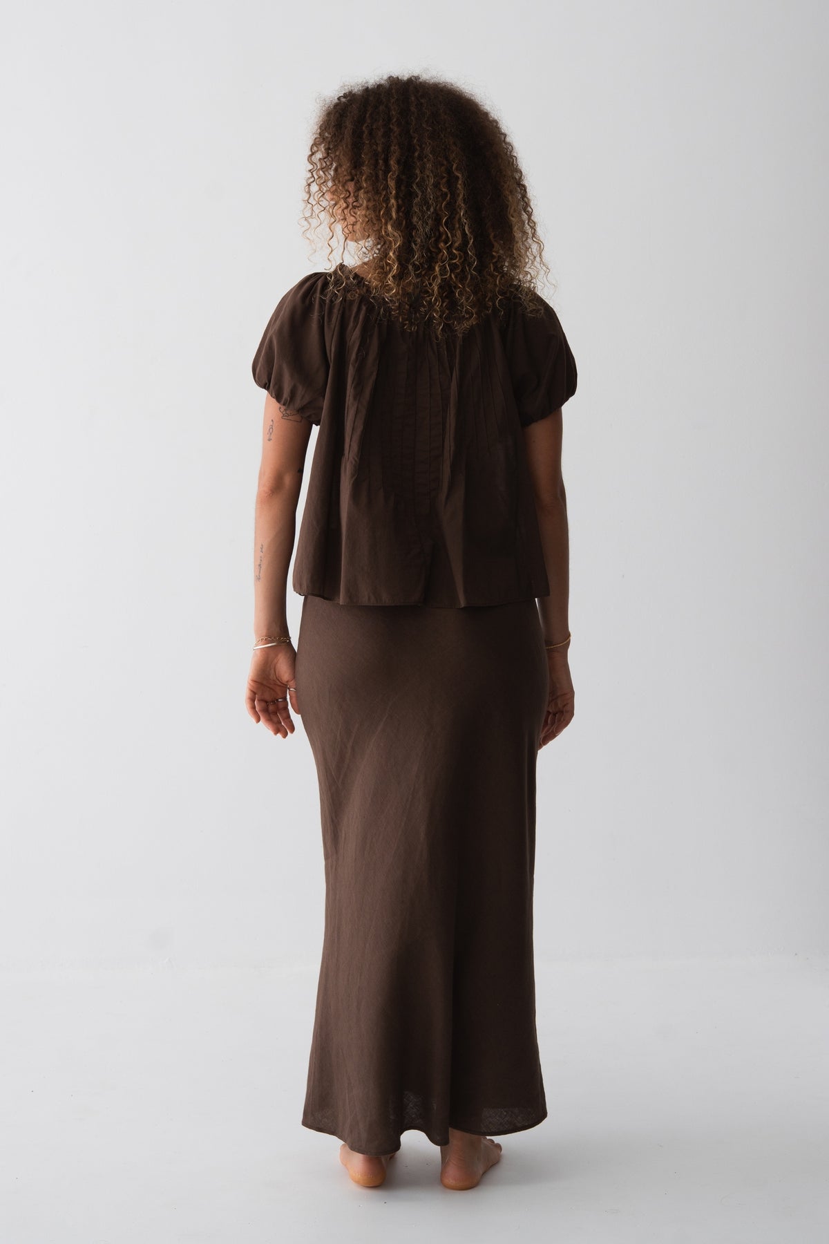 Tilly Cotton Voile Shirt in Chocolate - back view, gathered back and puff sleeves, worn with matching Riley Bias Linen Midi Skirt in Chocolate - Lilly Pilly Collection