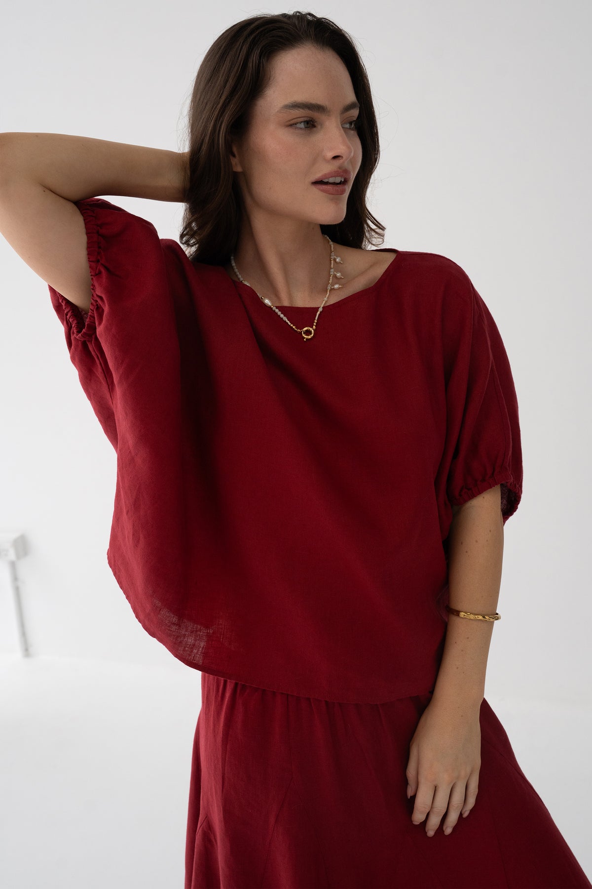 Tina Linen Top in Cherry Red - close-up of round neckline and oversized batwing sleeve, styled with matching Riley Linen maxi skirt - Lilly Pilly Collection