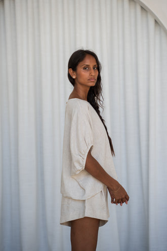 Tina Linen Top in Oatmeal - side profile, round neckline and puff sleeves with elasticated cuffs, styled with matching Gaia Linen shorts - Lilly Pilly Collection