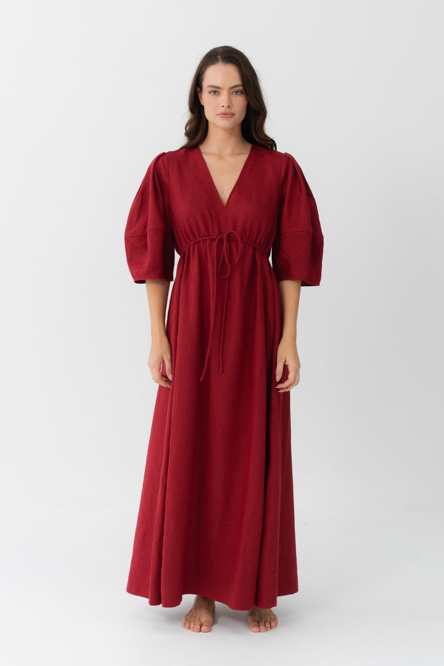 Front view of a woman wearing the Vida Linen maxi dress in Cherry Red in a studio setting - Lilly Pilly Collection