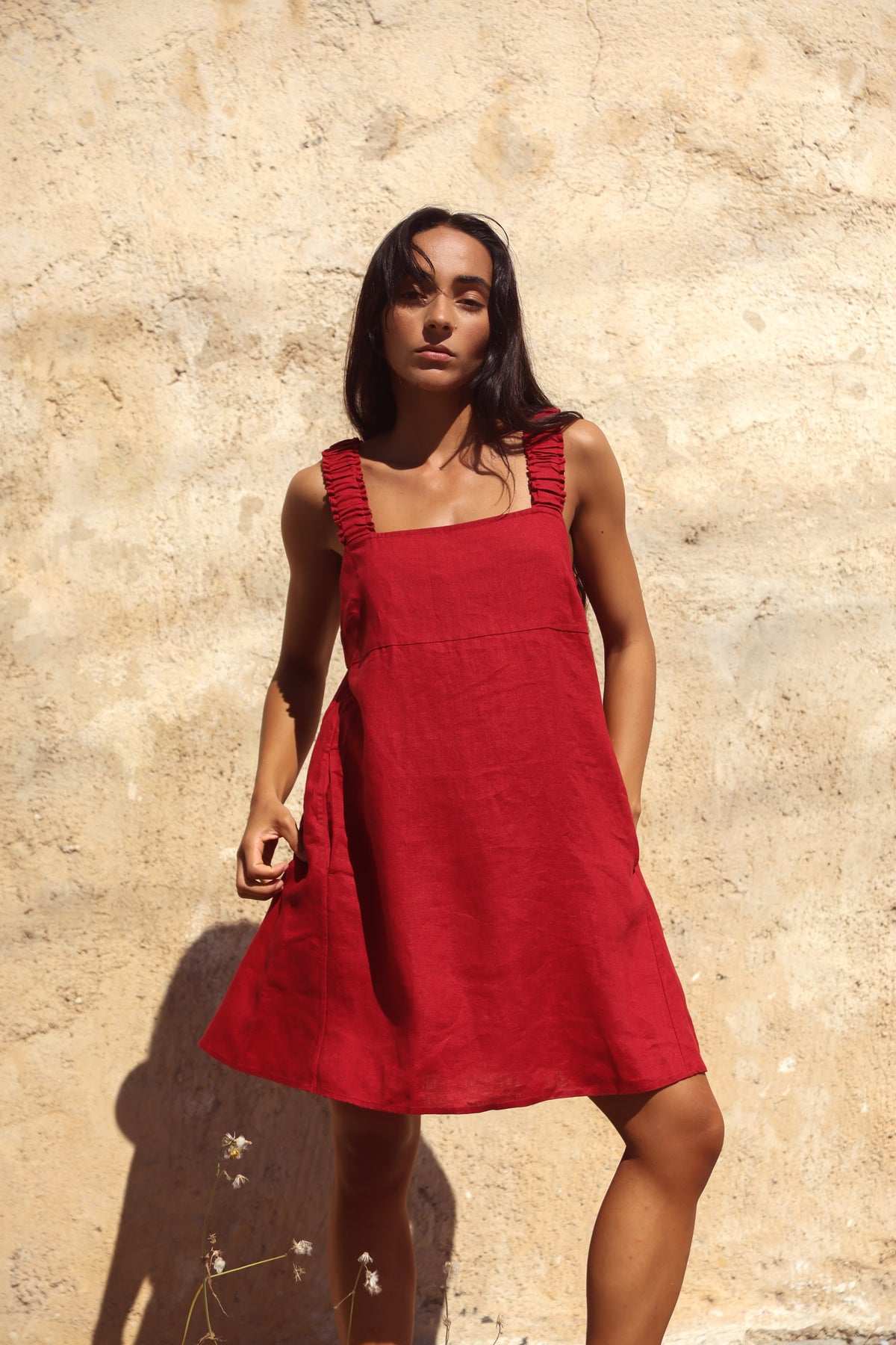 Zahra Linen Mini Dress in Cherry Red - full front view, ruched straps and square neckline, sandstone backdrop - Lilly Pilly Collection
