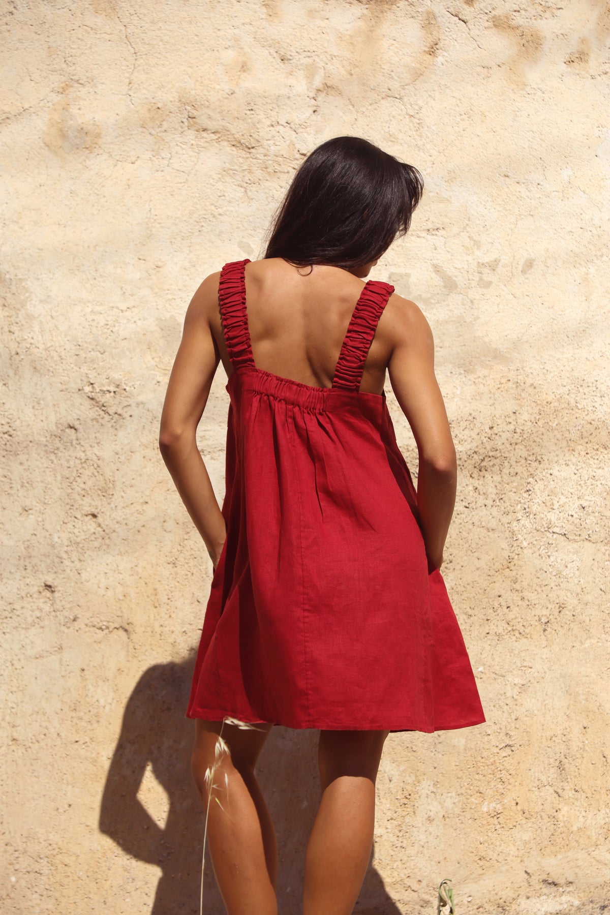 Zahra Linen Mini Dress in Cherry Red - back view showing open back, ruched straps and gathered waist - Lilly Pilly Collection