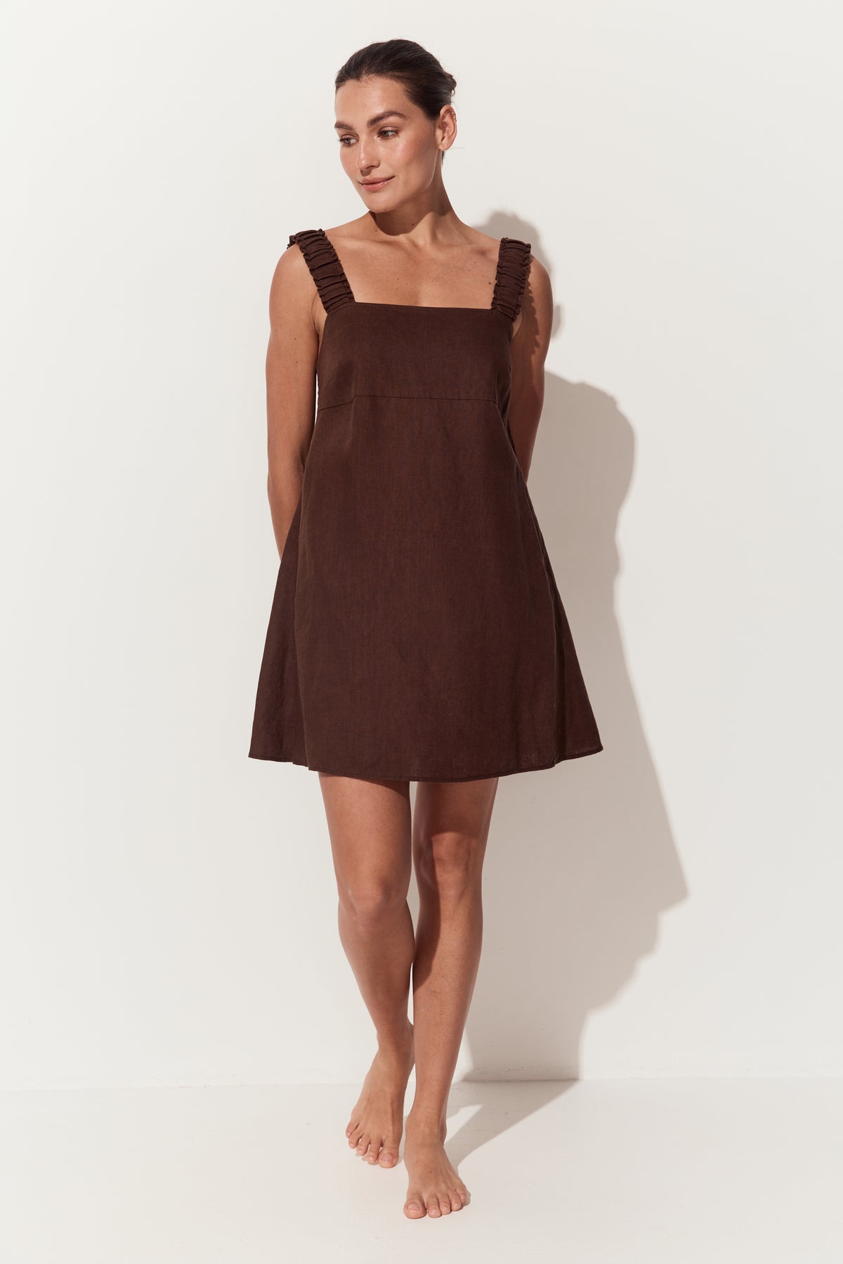 Zahra Linen Mini Dress in Chocolate - full front view looking to her right - Lilly Pilly Collection