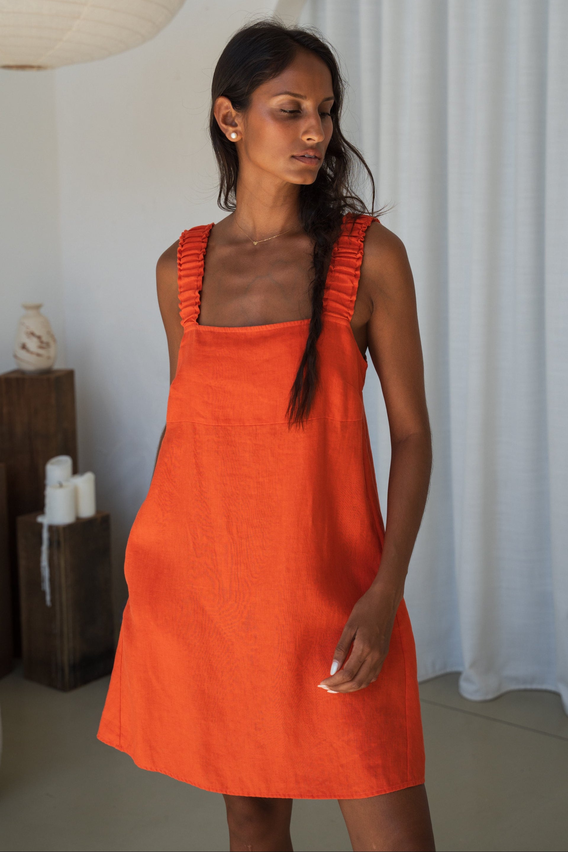 LILLY PILLY woman in an spritz Zahra linen dress standing in front of a neutral background