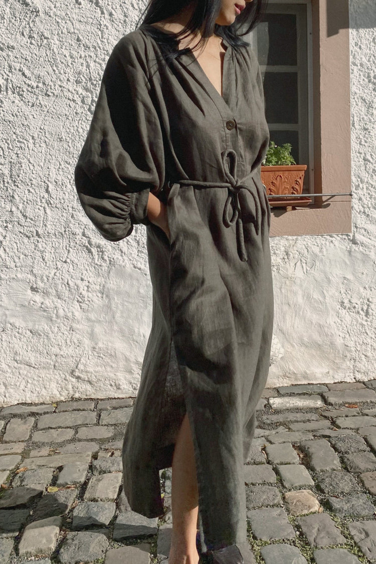 Mae Linen Dress in Khaki - three quarter front view standing on a cobble stone street - Lilly Pilly Collection