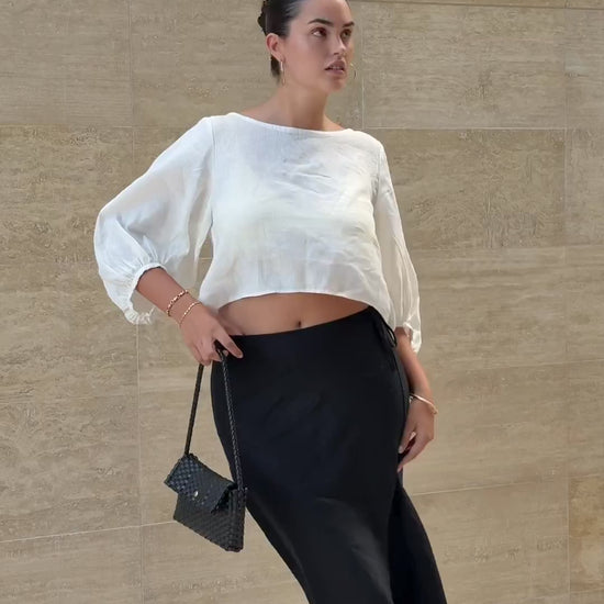 LILLY PILLY woman wearing Demi ivory linen top with Riley black linen skirt