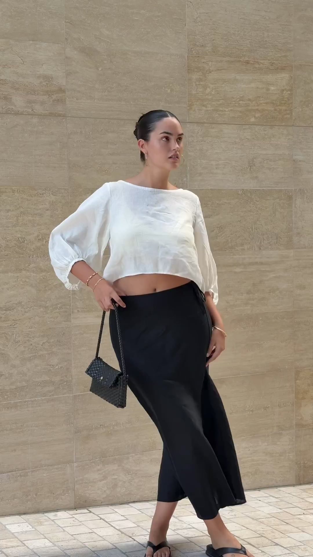LILLY PILLY woman wearing Demi ivory linen top with Riley black linen skirt