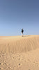 LILLY PILLY woman on a sand dune wearing Taylor merino knit and Hannah linen skirt