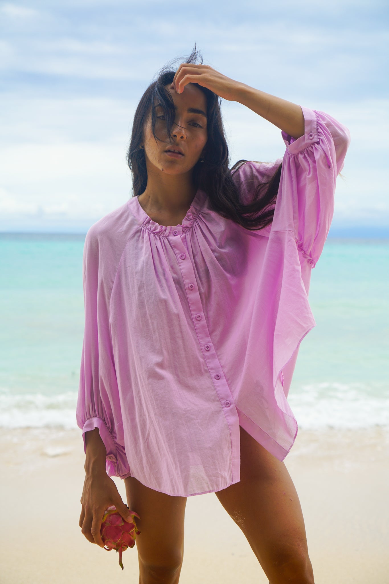 Close up of LILLY PILLY woman wearing a orchid Thalia cotton voile shirt  blouse with a blurred background by the ocean